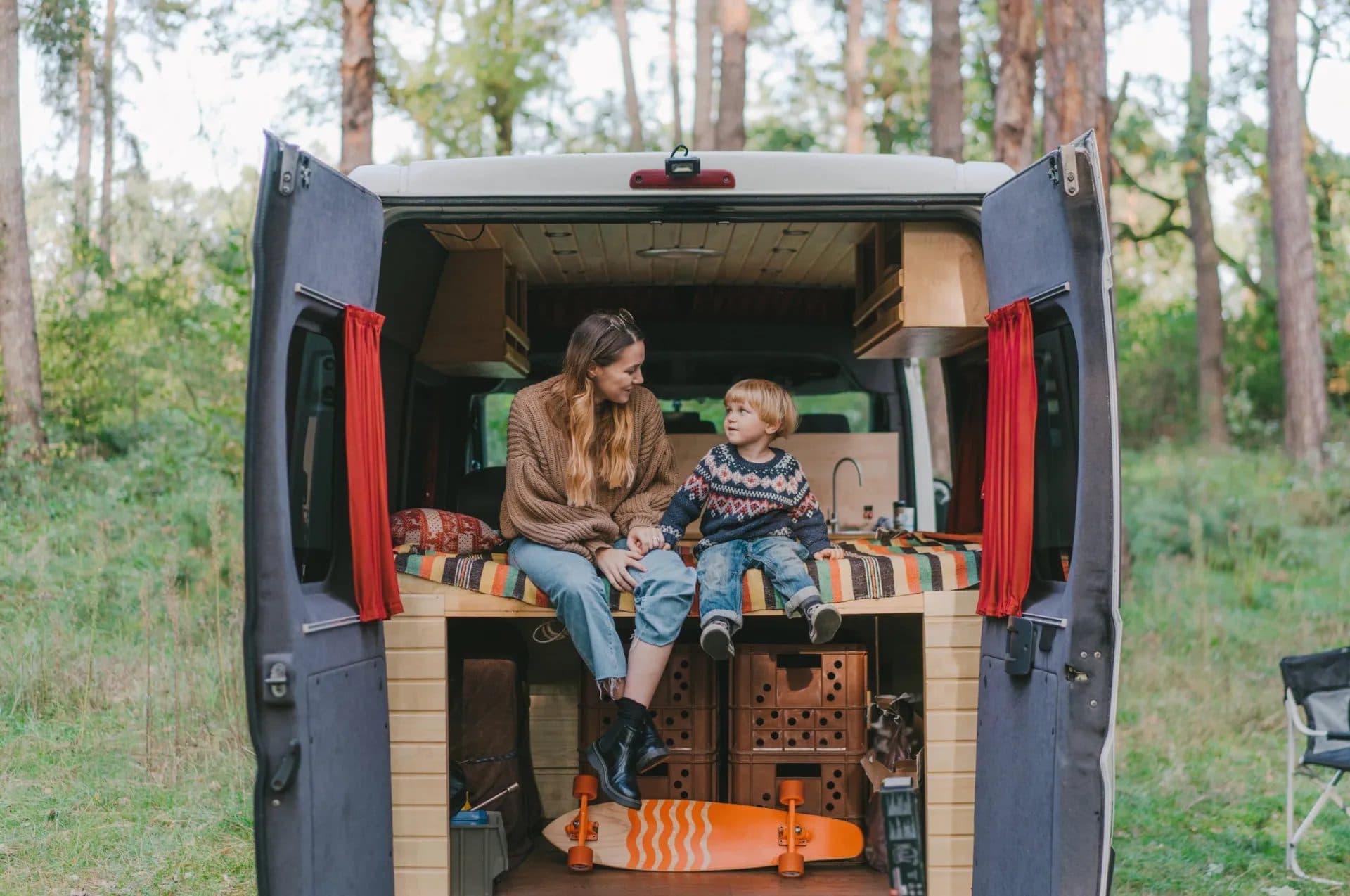 Family enjoying the interior living space of a Reliable Campers family camper van conversion
