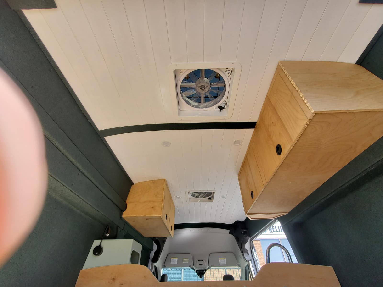 Rear doors open showing the bed platform and cabinets