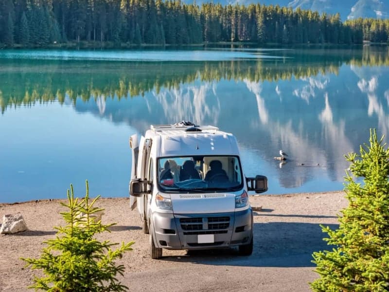 Camper van by a mountain lake