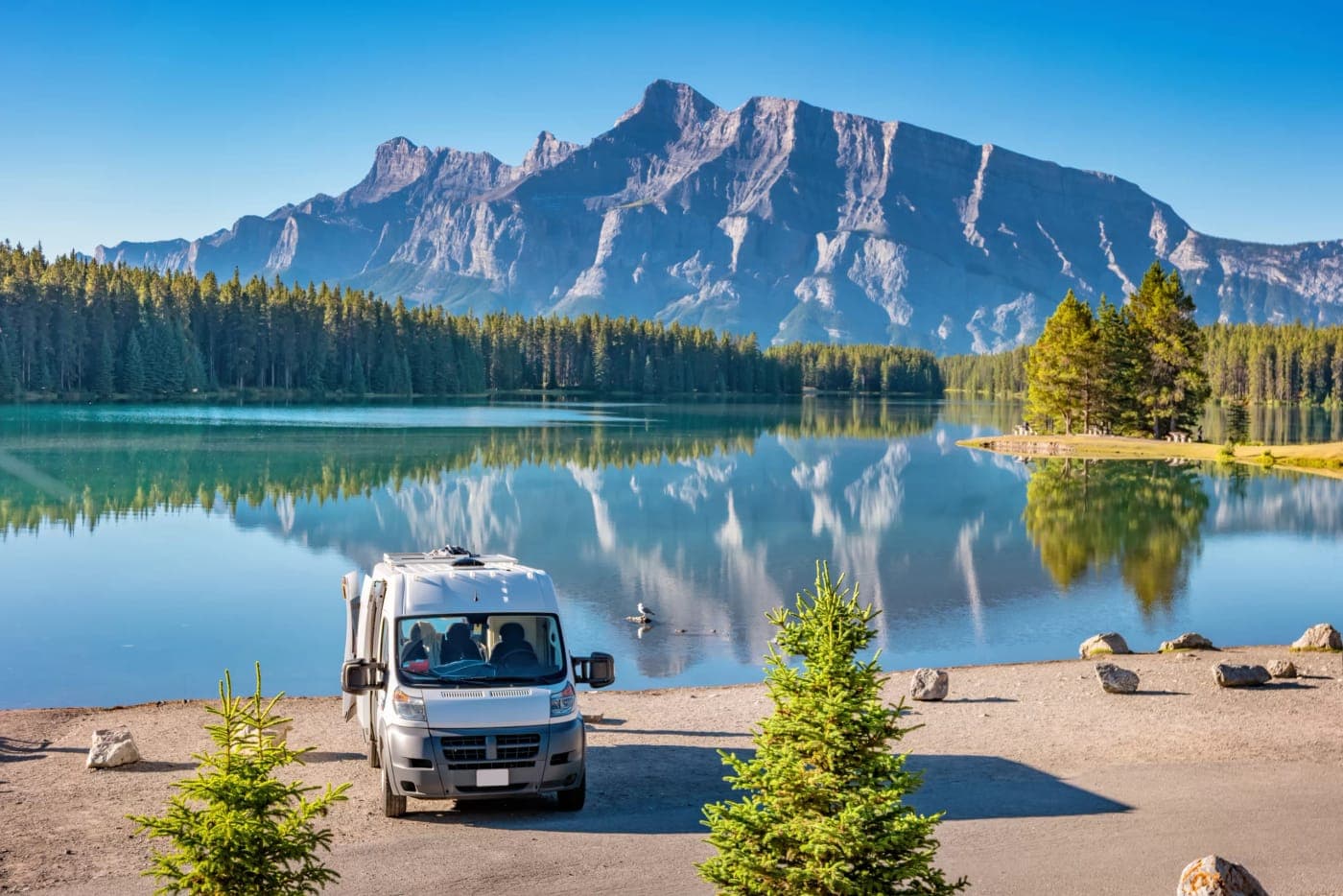 Camper van by a mountain lake