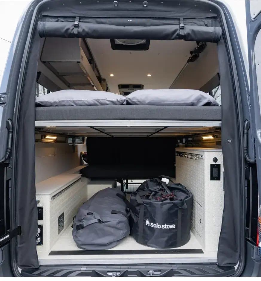 Camper van rear garage storage loaded with adventure gear
