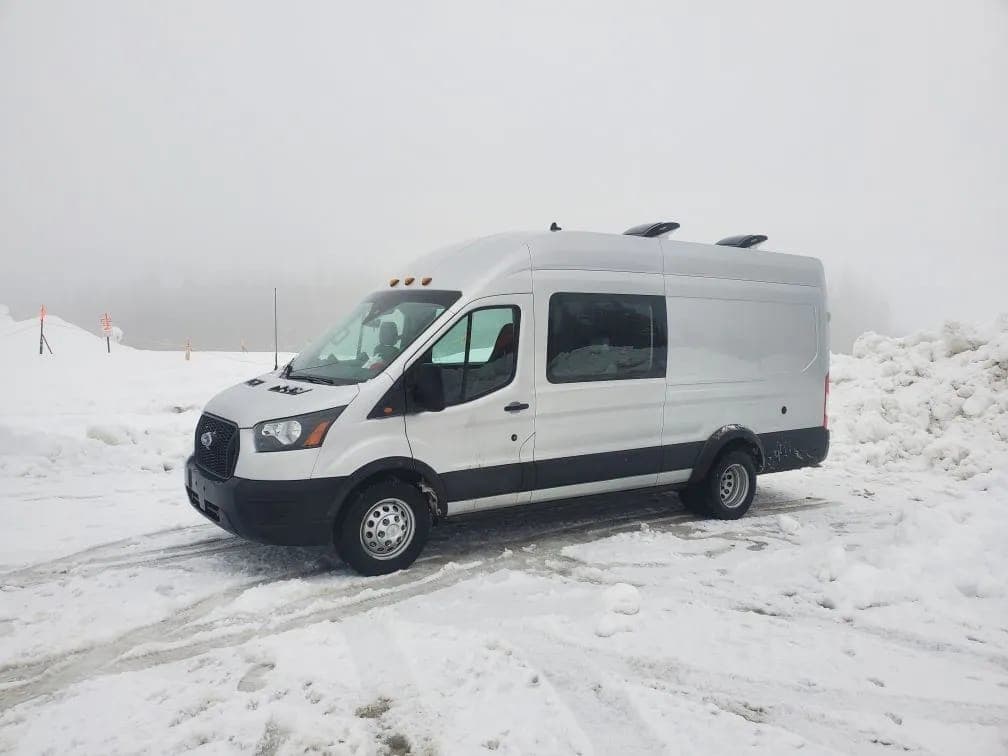 Reliable Campers ski van in the snow near Canmore
